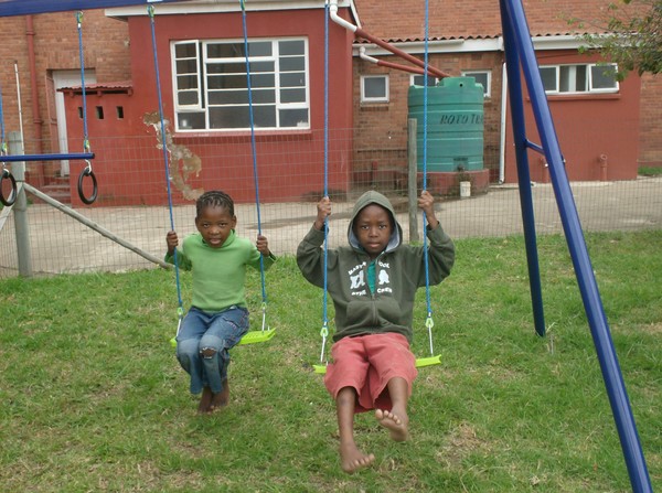 Nomuselelo and Anele swinging outside Thembalethu Children's Shelter in 2007. Nomuselelo and Anele swinging outside Thembalethu Children's Shelter in 2007.
