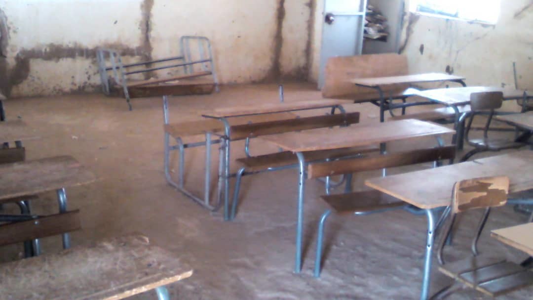 Current state of most of the inside classrooms, broken chairs and earthen.