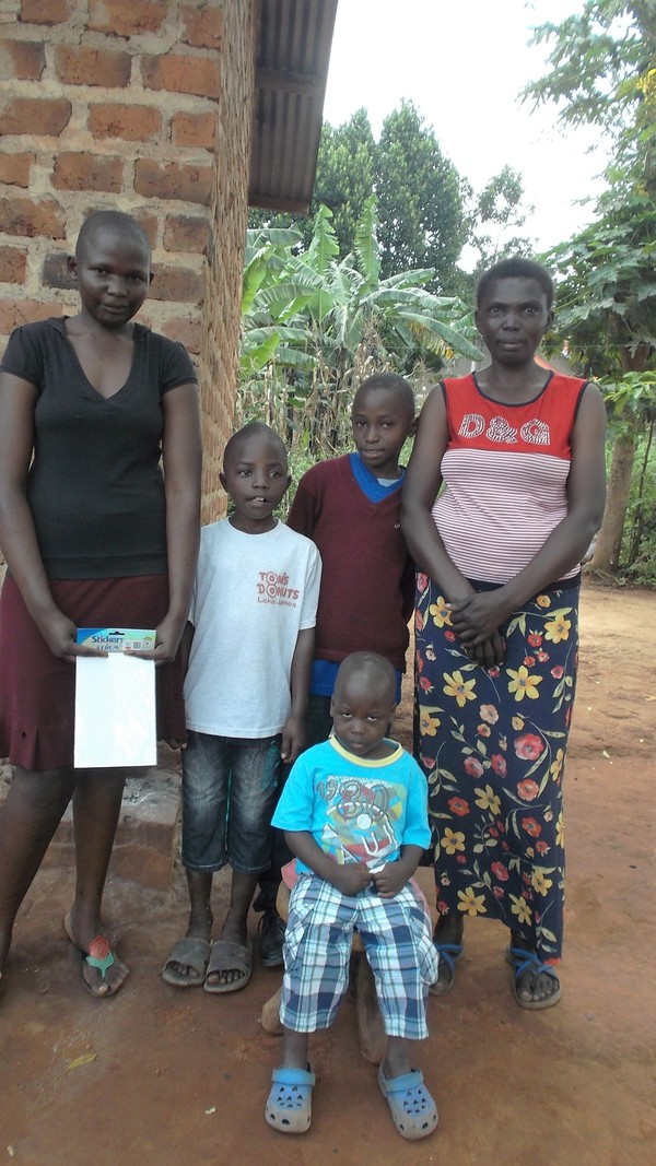 Alex with his family in his home village