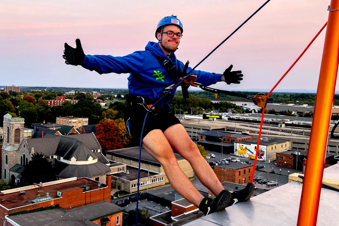 A rappeler posing with arms at on top of building