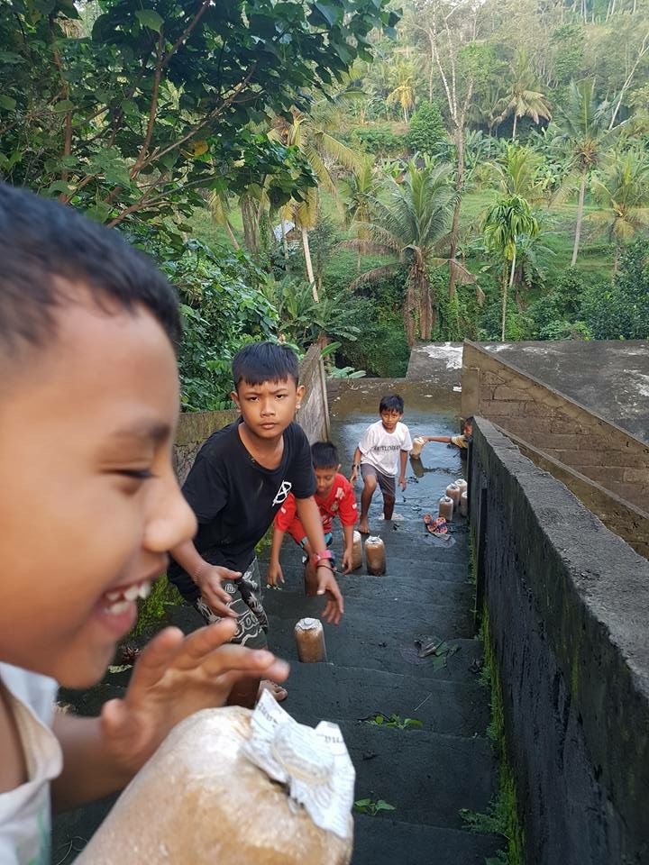 The kids are helping is unload mushroom bags from the truck