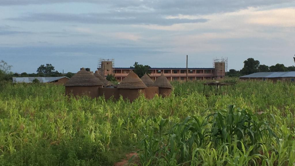 (Here you can see the school in the background. The gorgeous mud houses are typical homes in our peaceful village)