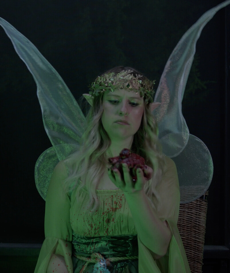 Ellie holding bloody heart