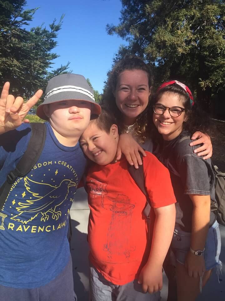 Two counselors with two teens with Down syndrome