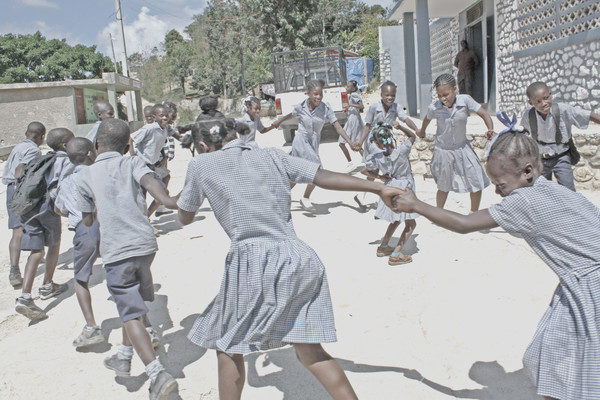 Children dancing outside the school.