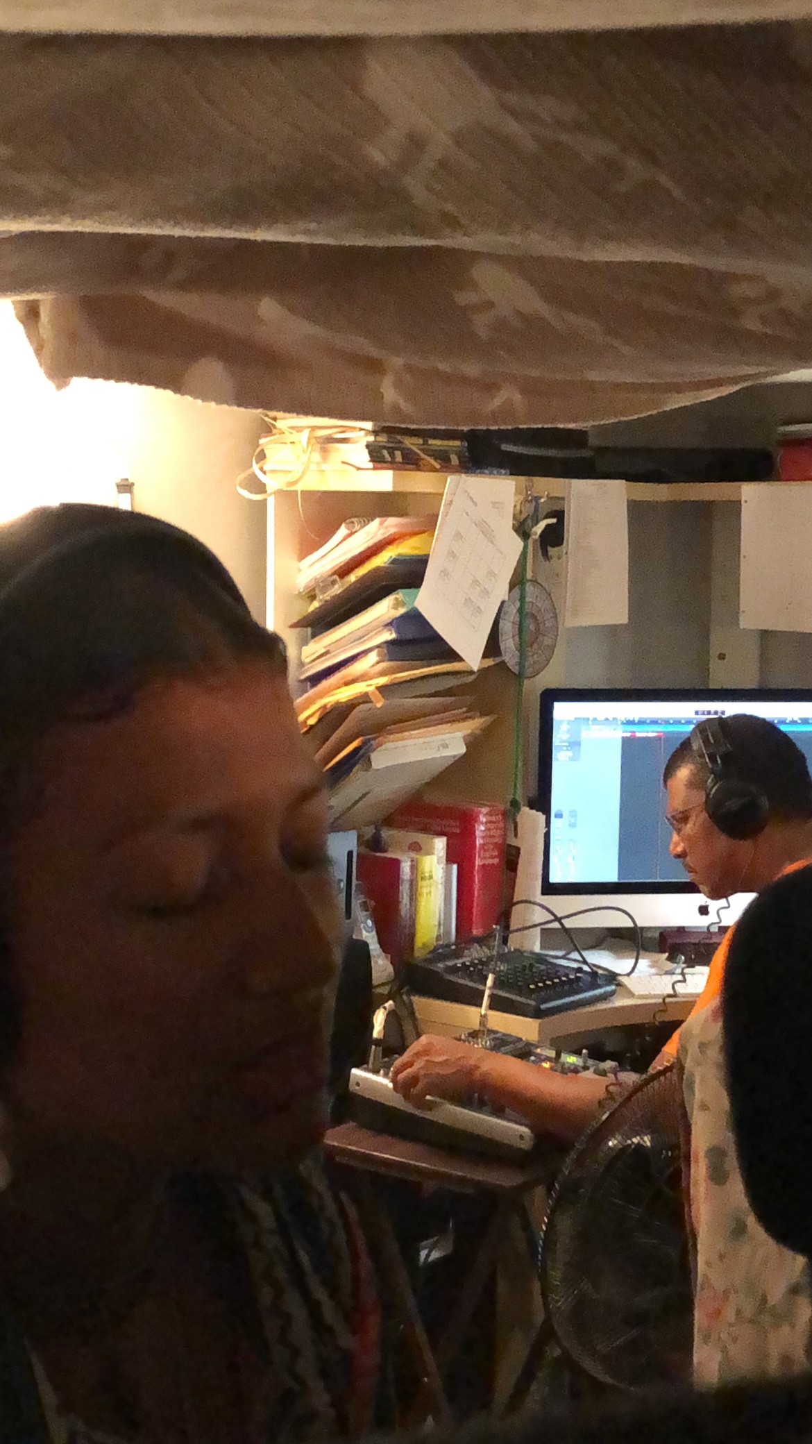 Photo of Gerry at work, with a singer  in the foreground