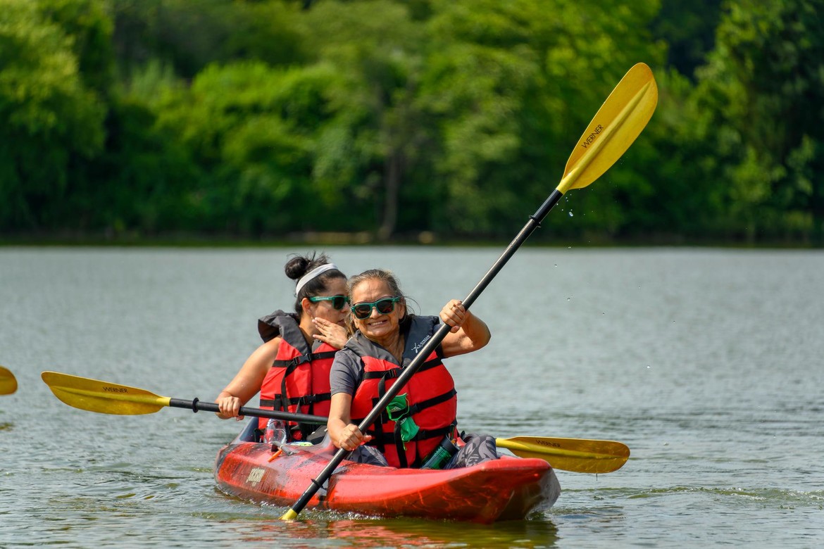 Two women flat water kayaking.