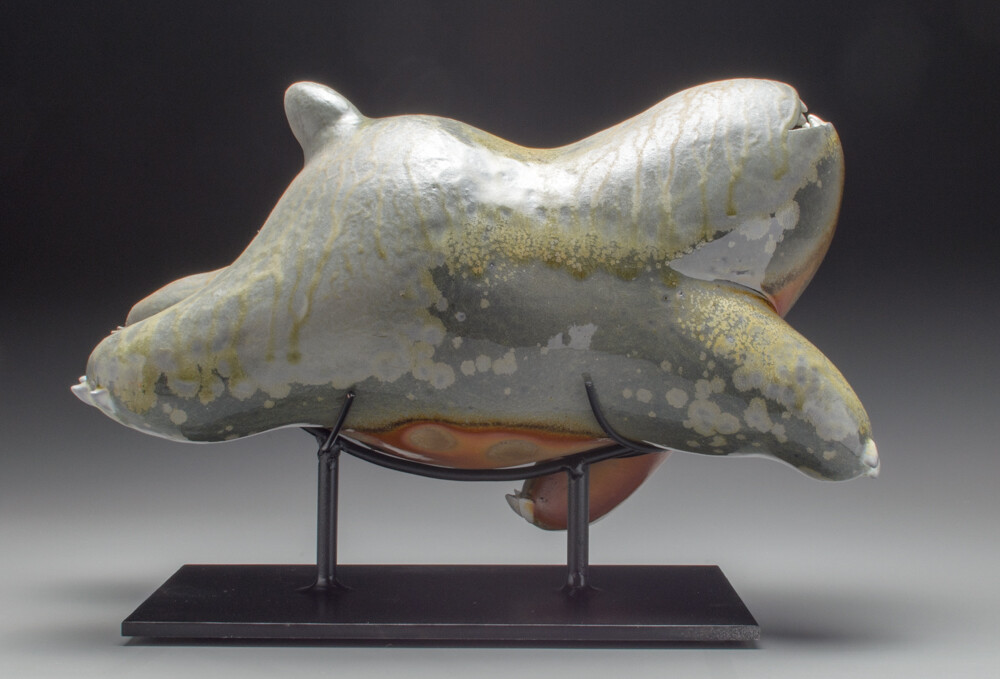 a sculpture of a swimming beast