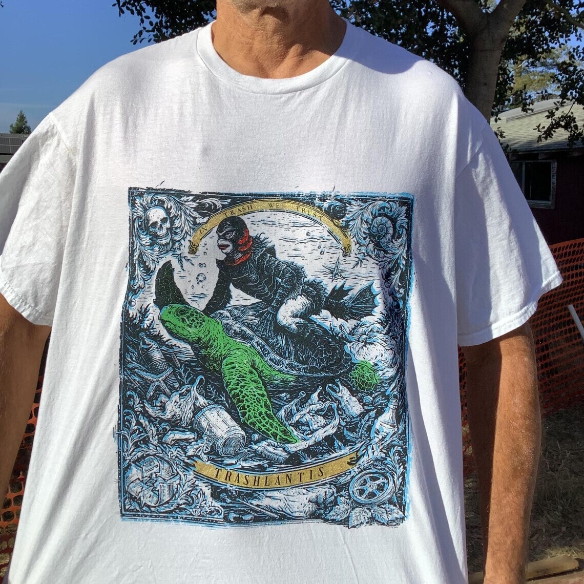 T-shirt hand screened with Trashlantean riding a sea turtle