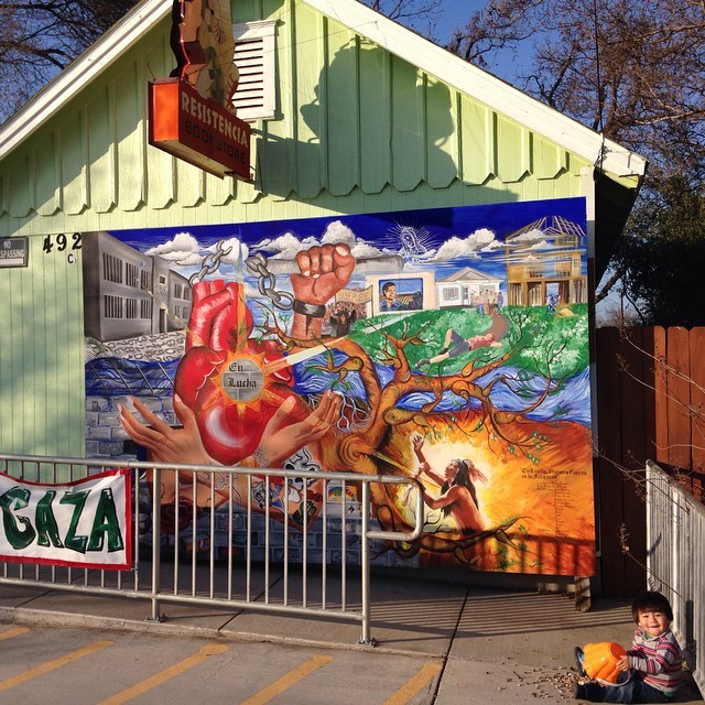 Little one playing in front of our mural