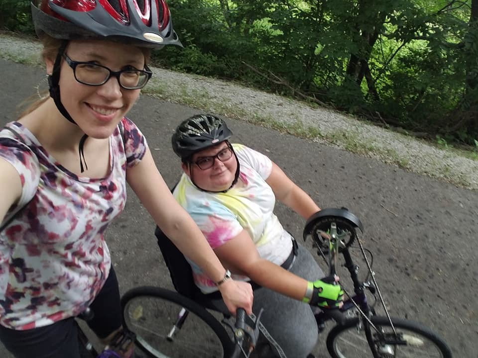 Sarah biking with a friend