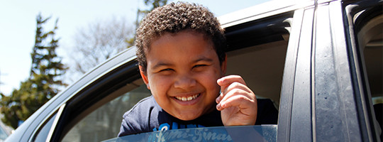 Boy smiling in car in drive-through