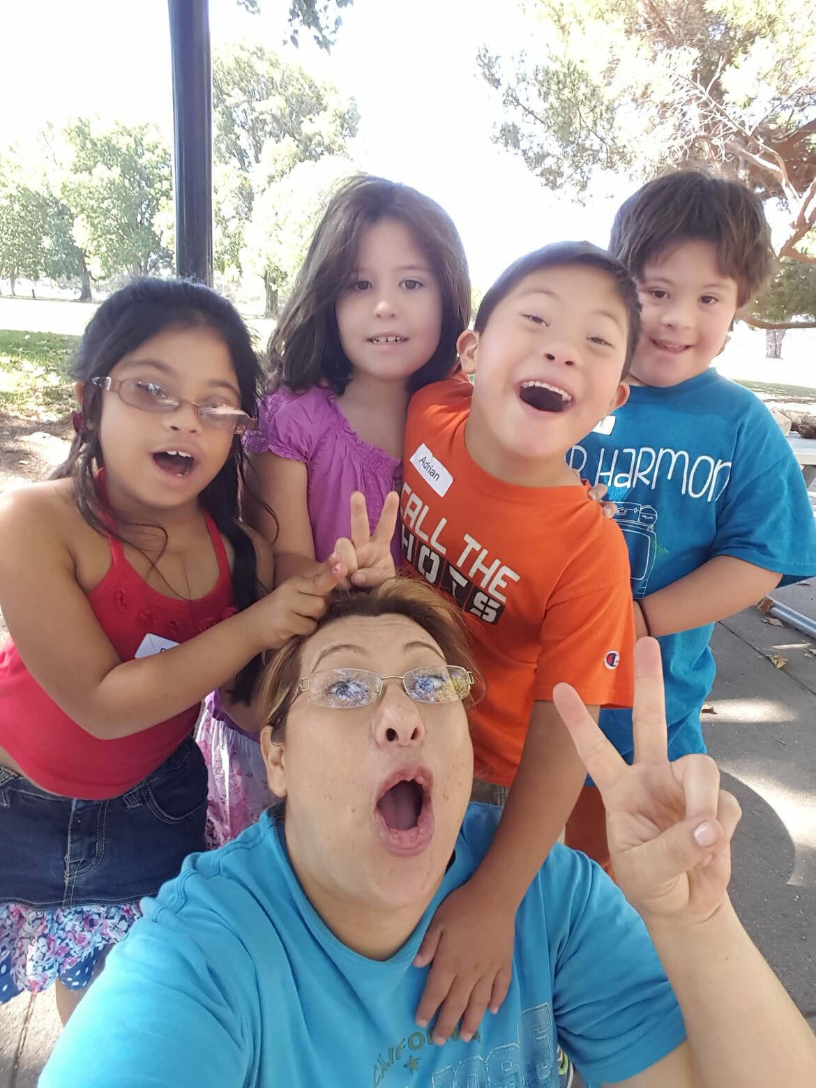 Camp counselor with three kids with Down syndrome and a sibling