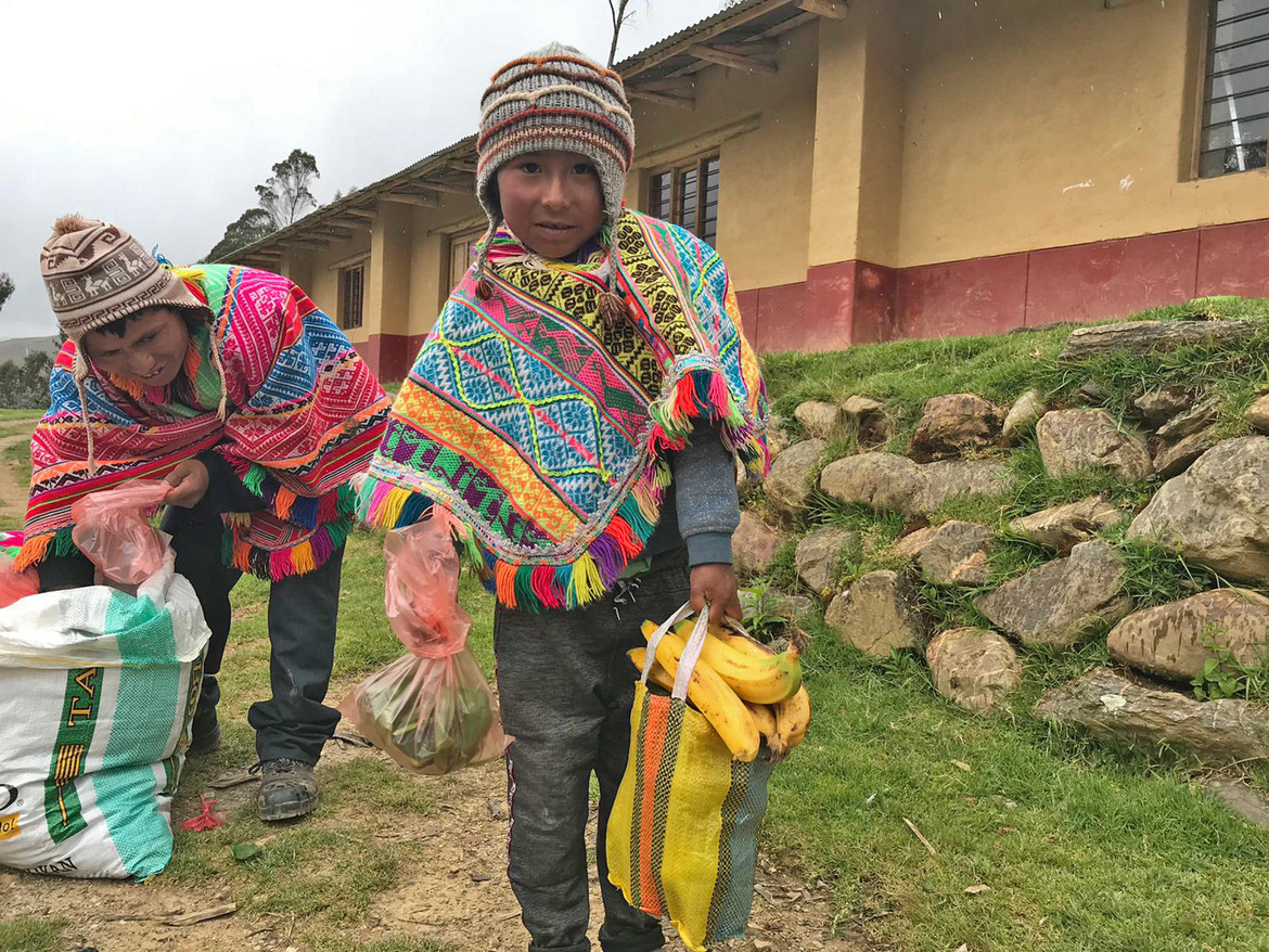Locals receiving fruits to feed their families