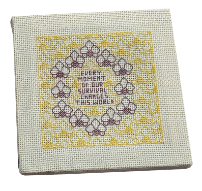 Embroidery work with purple orchid flowers in a ring, framing the text "every moment of our survival changes this world"