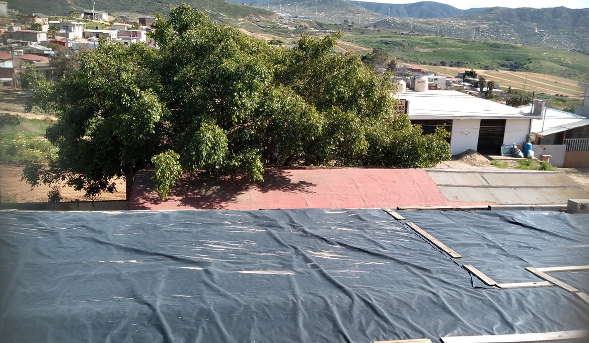An exterior shot of a portion of our roofing situation at Colony 89's rehab.