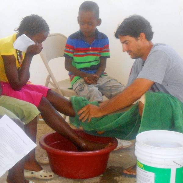 Kevin washing the children's feet.