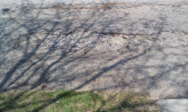 a close-up of their driveway that is falling apart :(