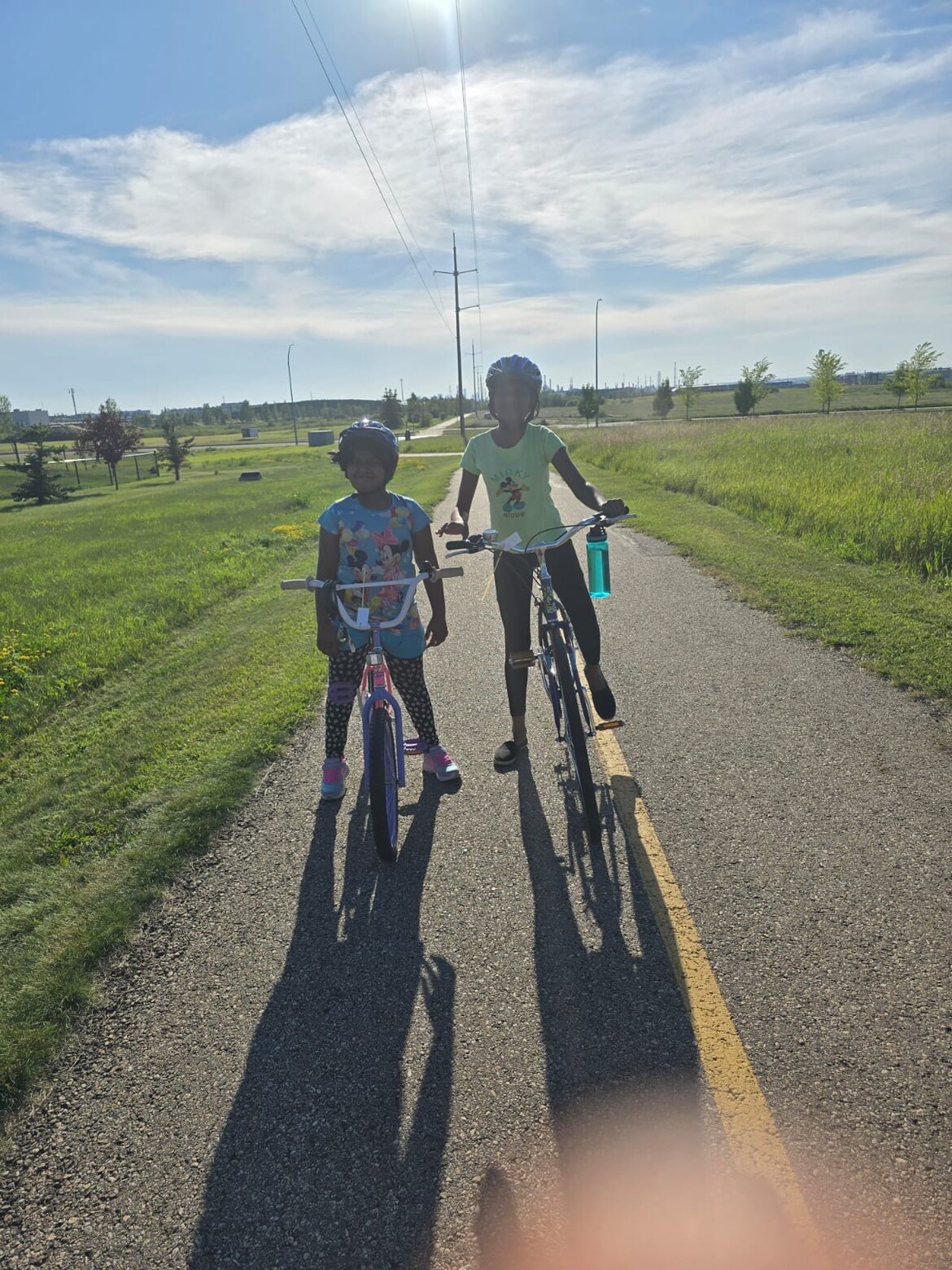 two happy kids riding bikes