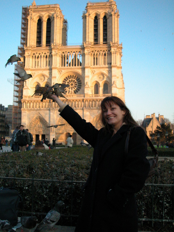 Feeding birds in Paris at Notre Dame